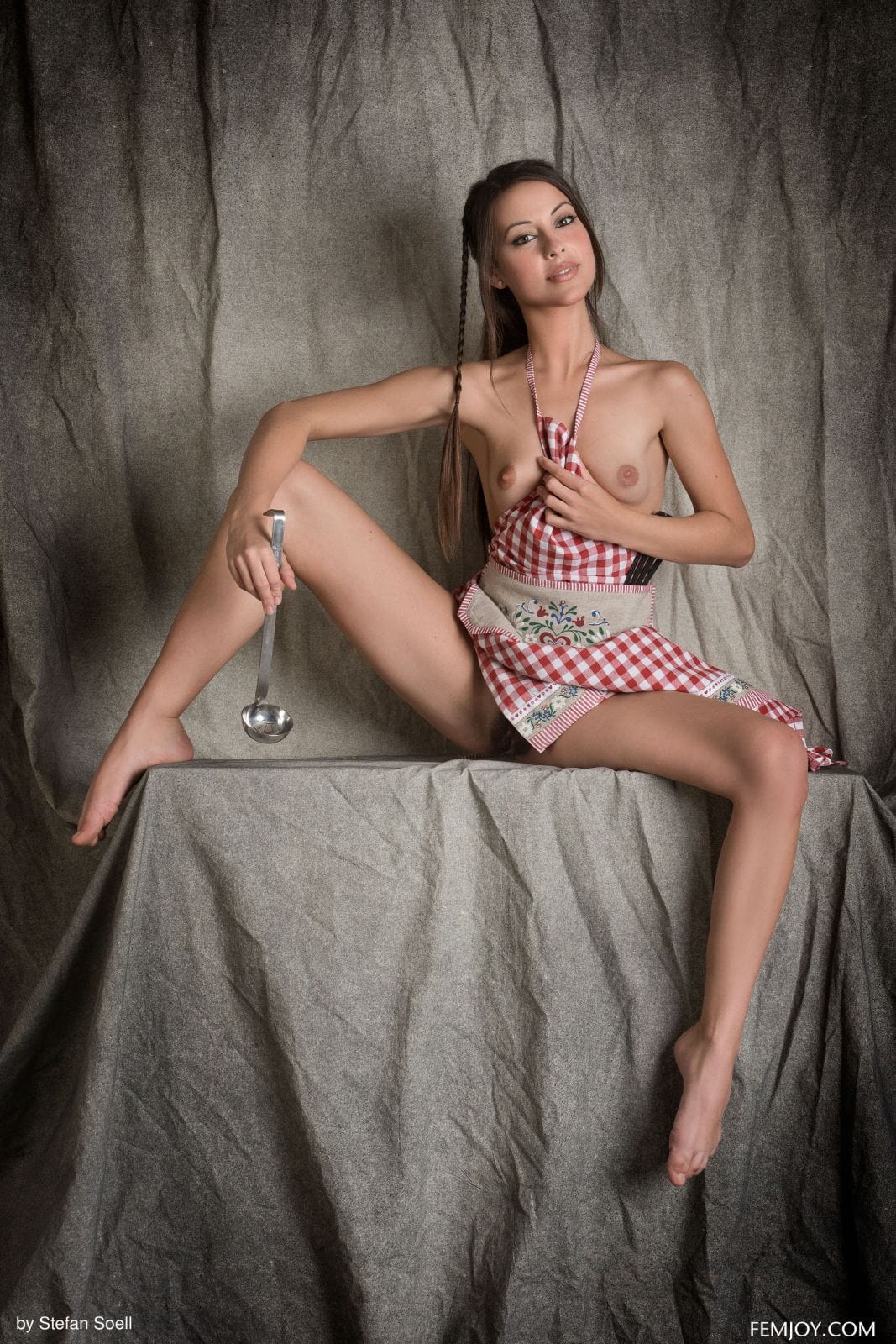 Lorena G takes off her red and white apron