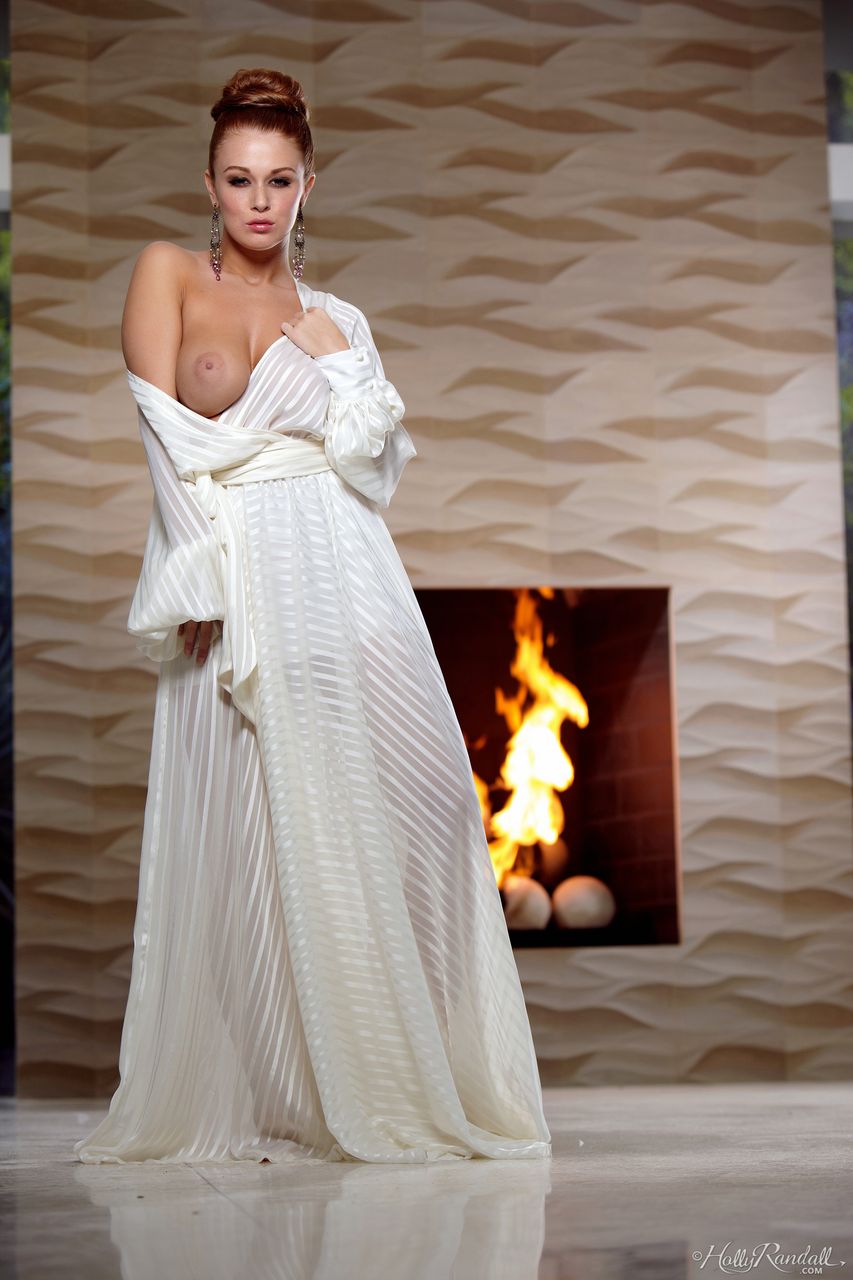 Leanna Decker exposing her big tits by a fireplace