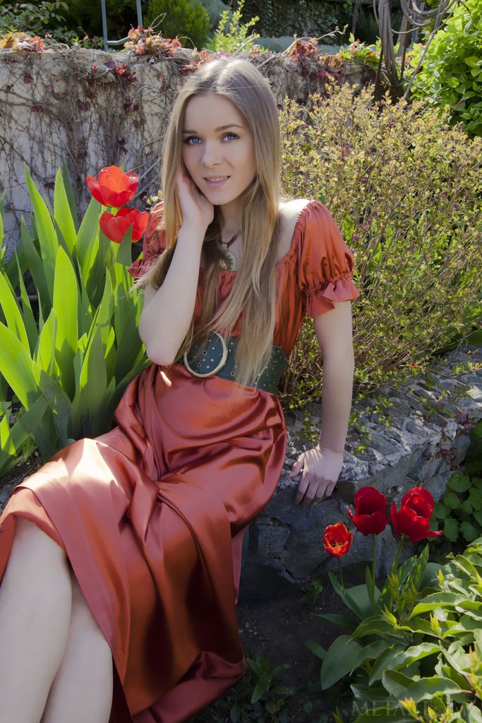 Katie A - Babe poses half-naked on a walk in a park