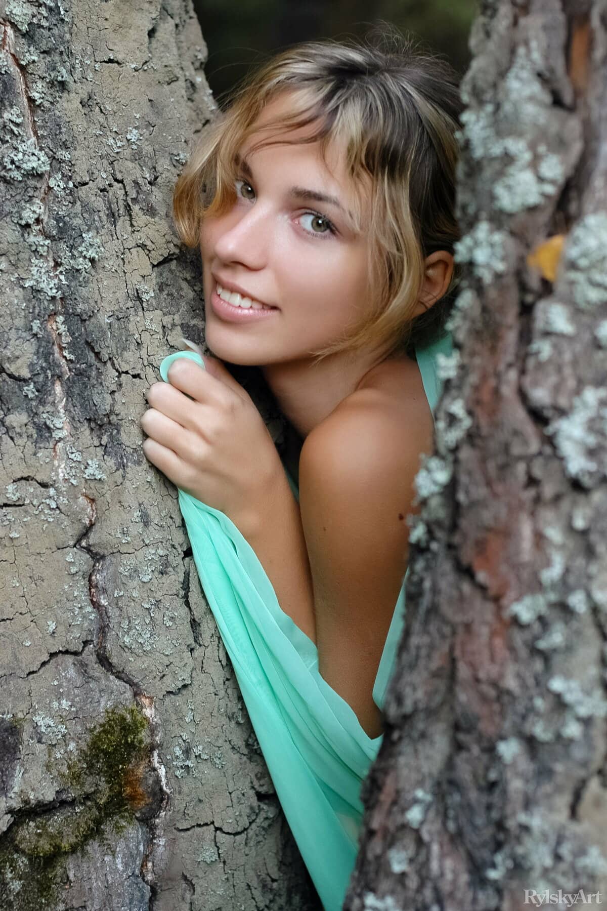 Natalia B shows her small breasts and trimmed pussy in the forest