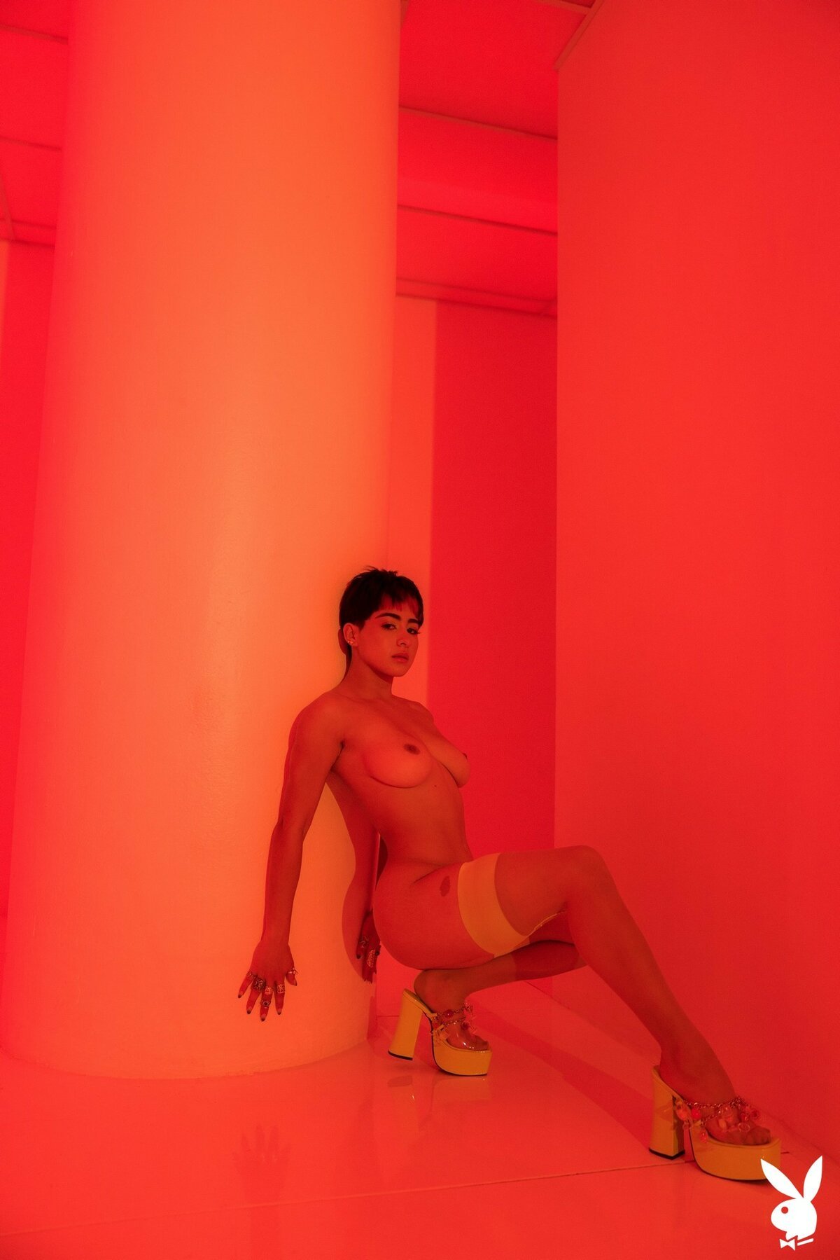 Mia Valentine looks seductive while posing in neon lingerie and stripping it off