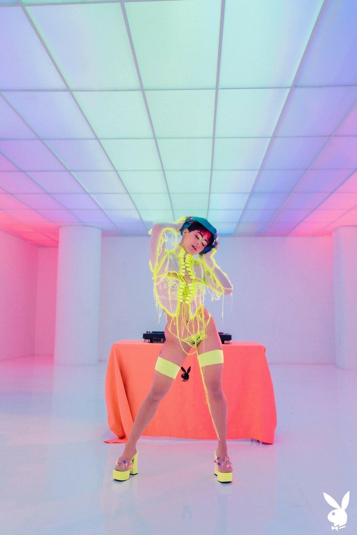 Mia Valentine looks seductive while posing in neon lingerie and stripping it off