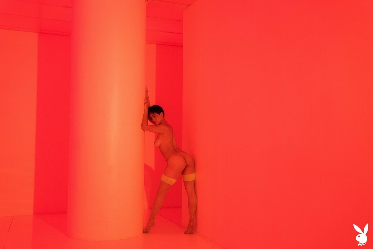 Mia Valentine looks seductive while posing in neon lingerie and stripping it off