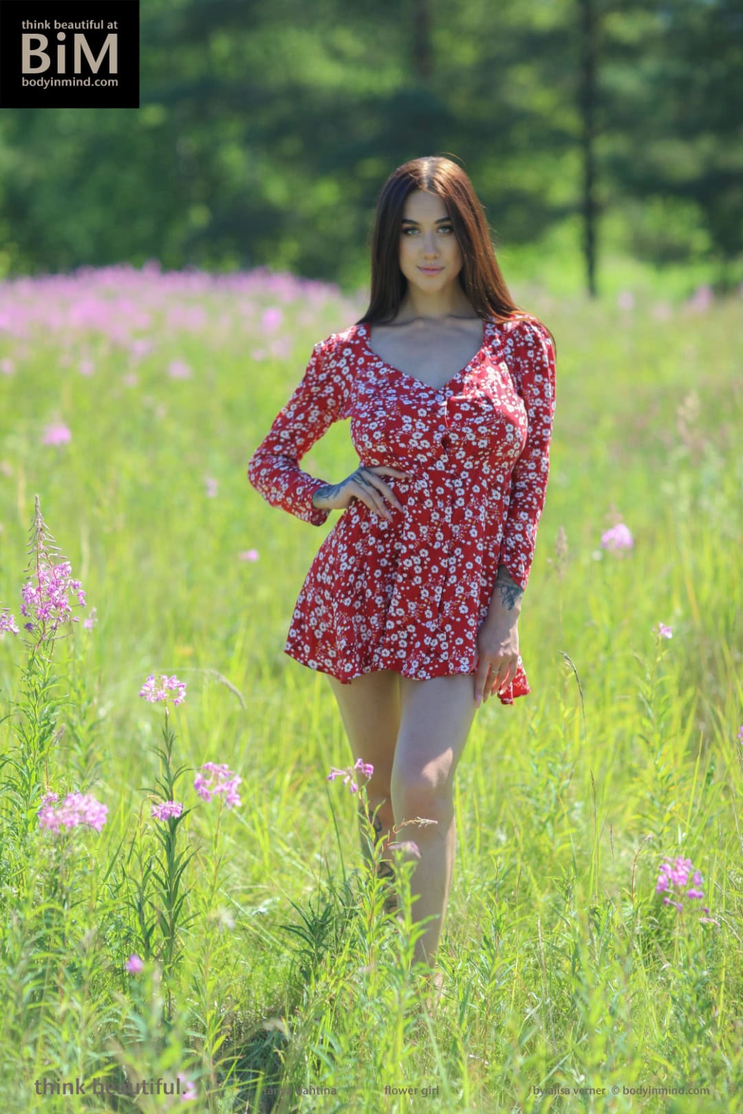 Tanya bares her inked physique with delicious natural tits in the grassy field